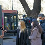 Journalists conduct a street interview in Ankara, capturing the pandemic's impact on daily life.