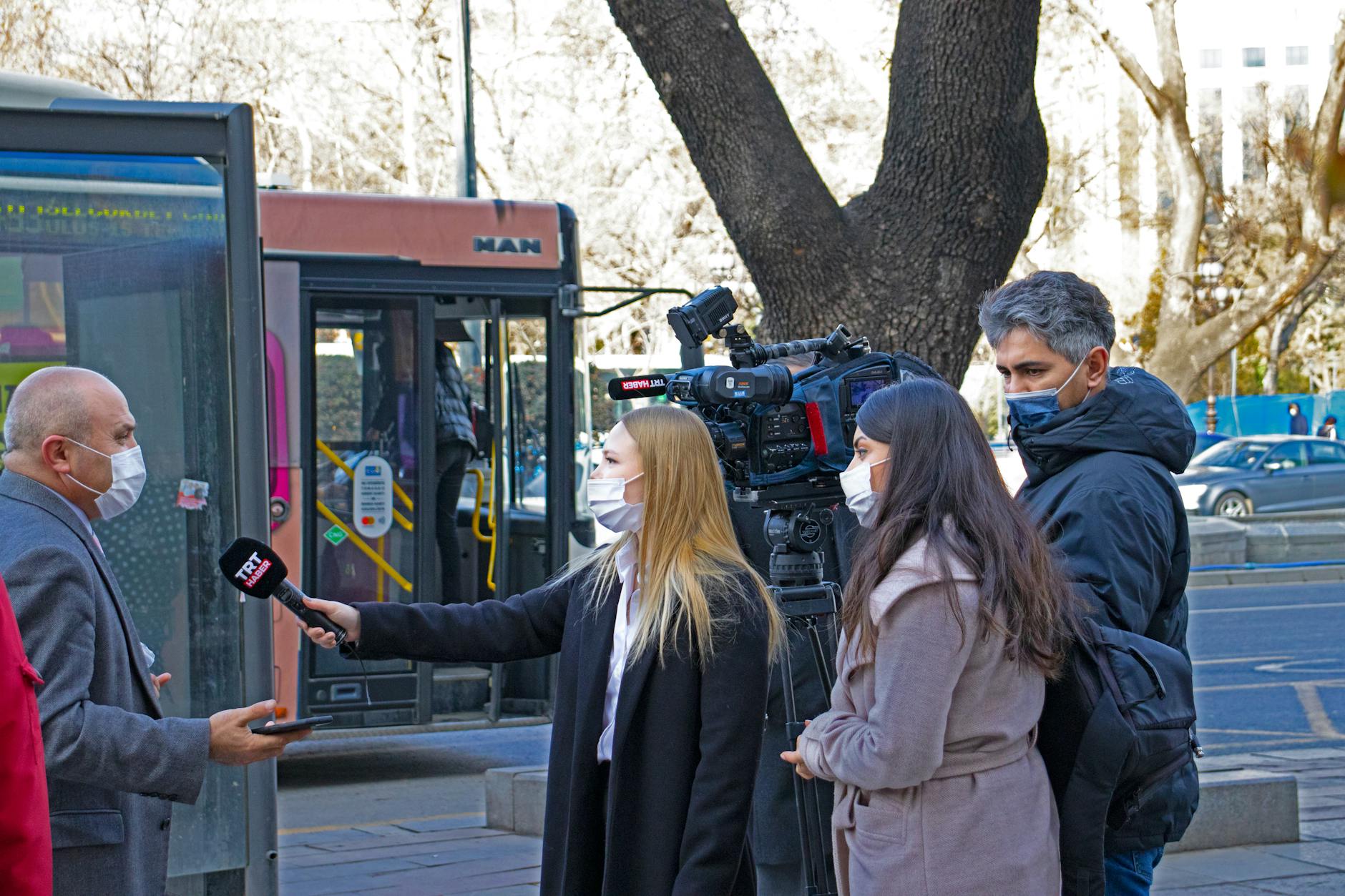 Journalists conduct a street interview in Ankara, capturing the pandemic's impact on daily life.
