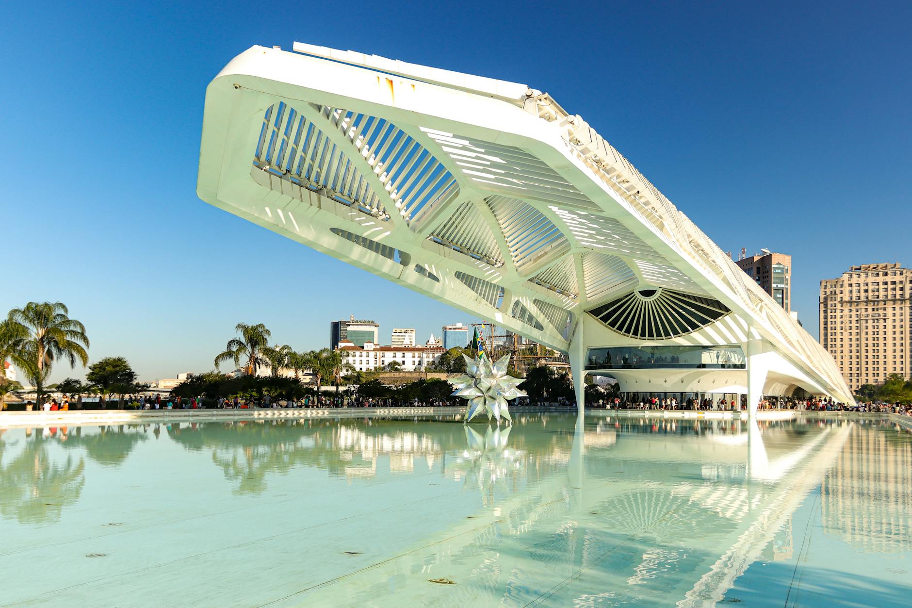 Explore the modern, futuristic design of Museu do Amanhã in Rio de Janeiro, reflecting on calm waters.