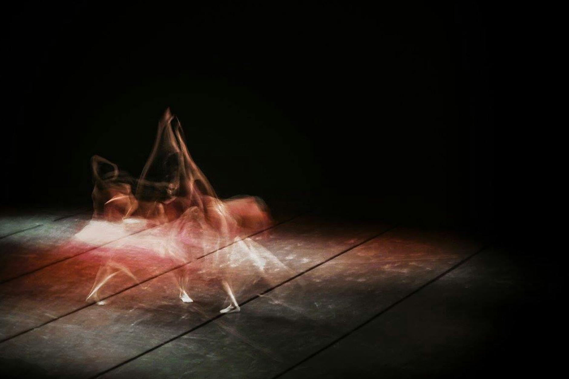 Artistic depiction of a ballet dancer captured with long exposure for a fluid motion effect.