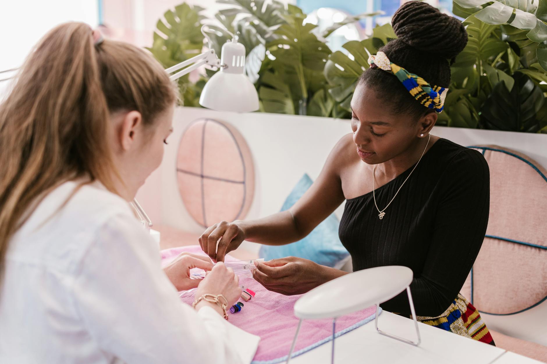 A professional manicurist provides nail care in a stylish, modern salon setting.