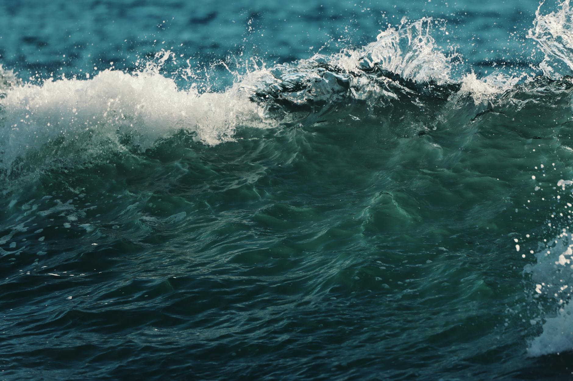 Dynamic wave crashing near Matosinhos, Portugal, showcasing vibrant ocean colors and dramatic motion.