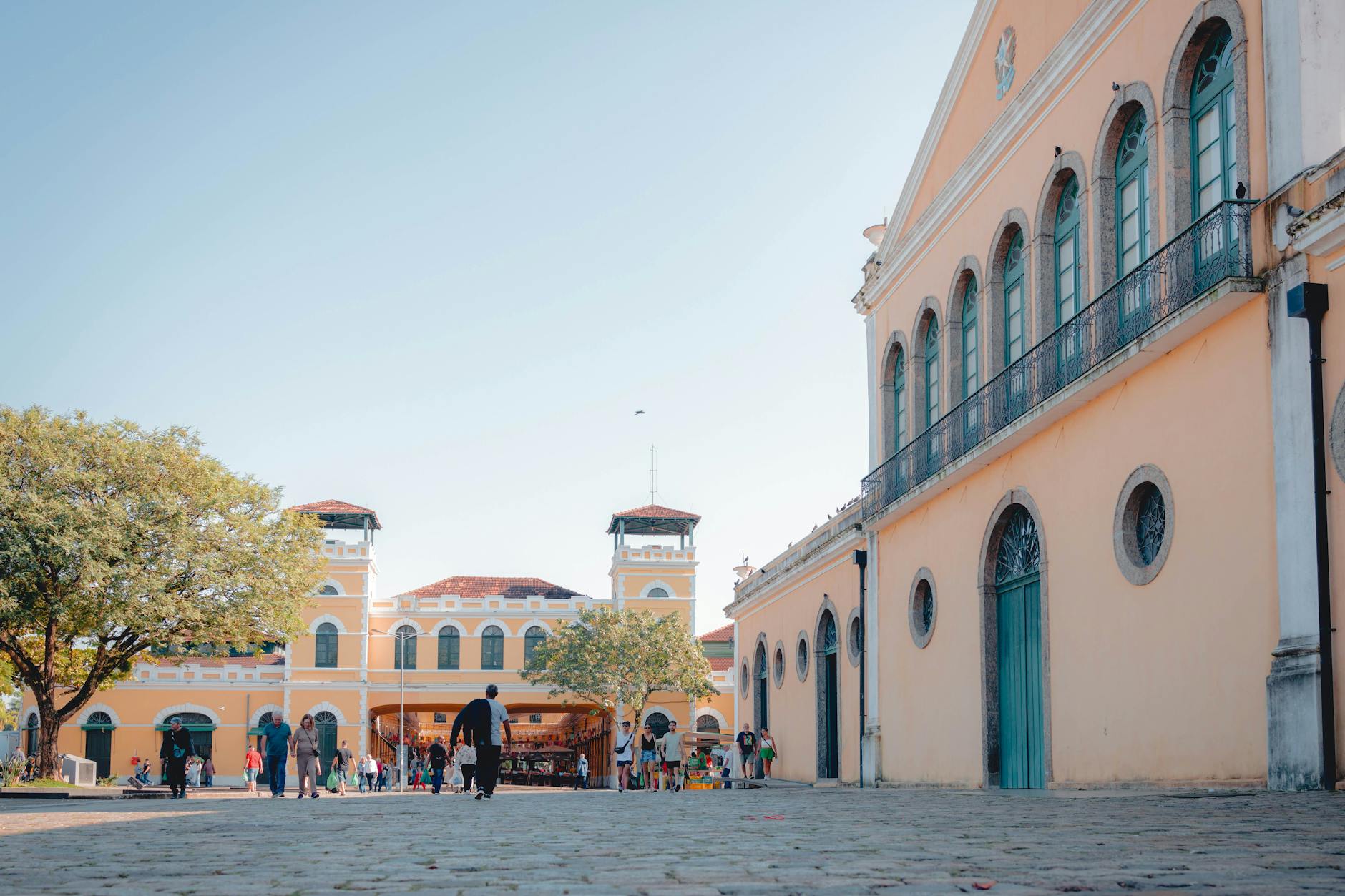Experience the vibrant Mercado Público in Florianópolis, bustling with people on a sunny day.