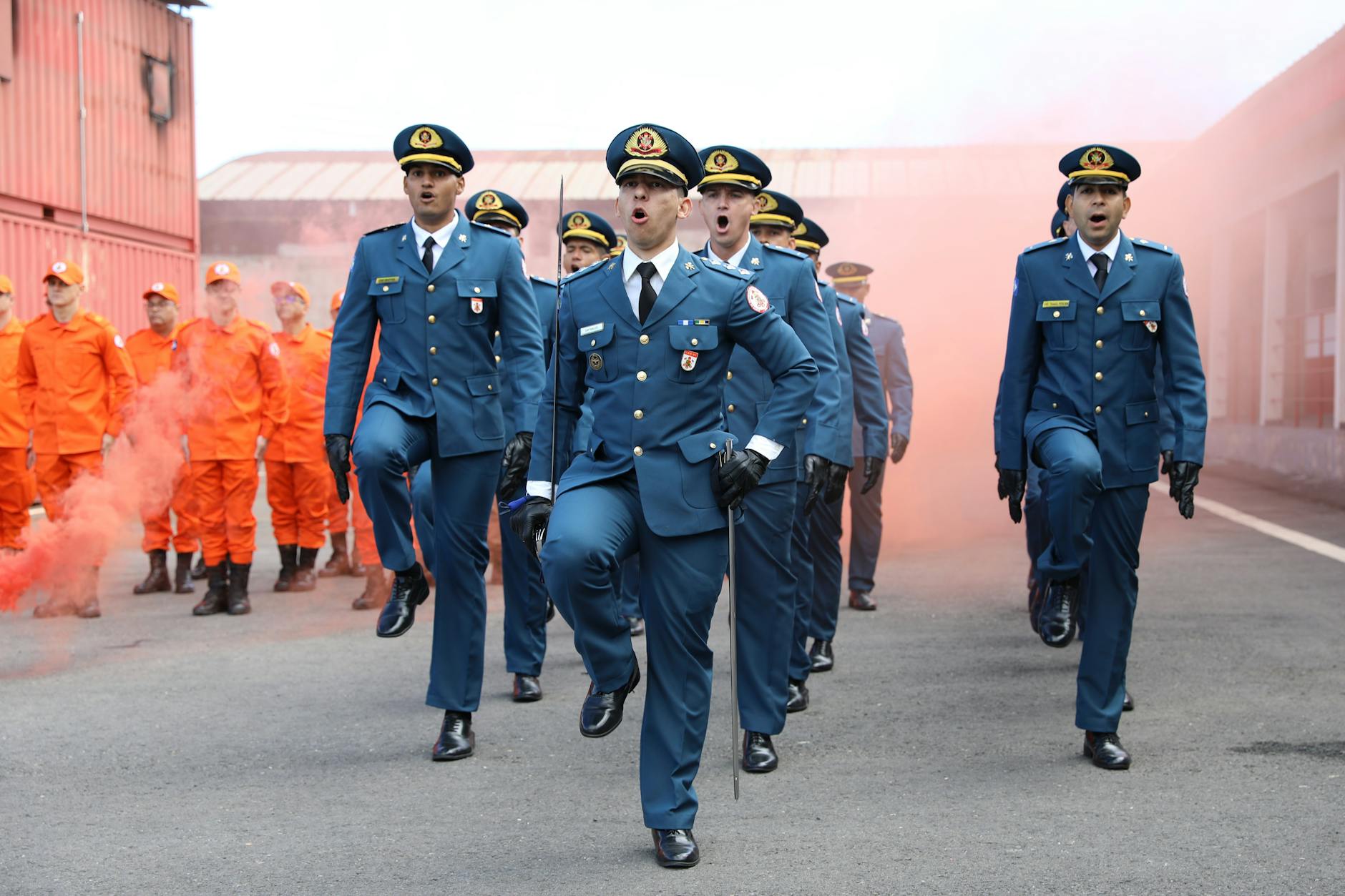 Military personnel march during a parade with firefighters, showcasing discipline and coordination.