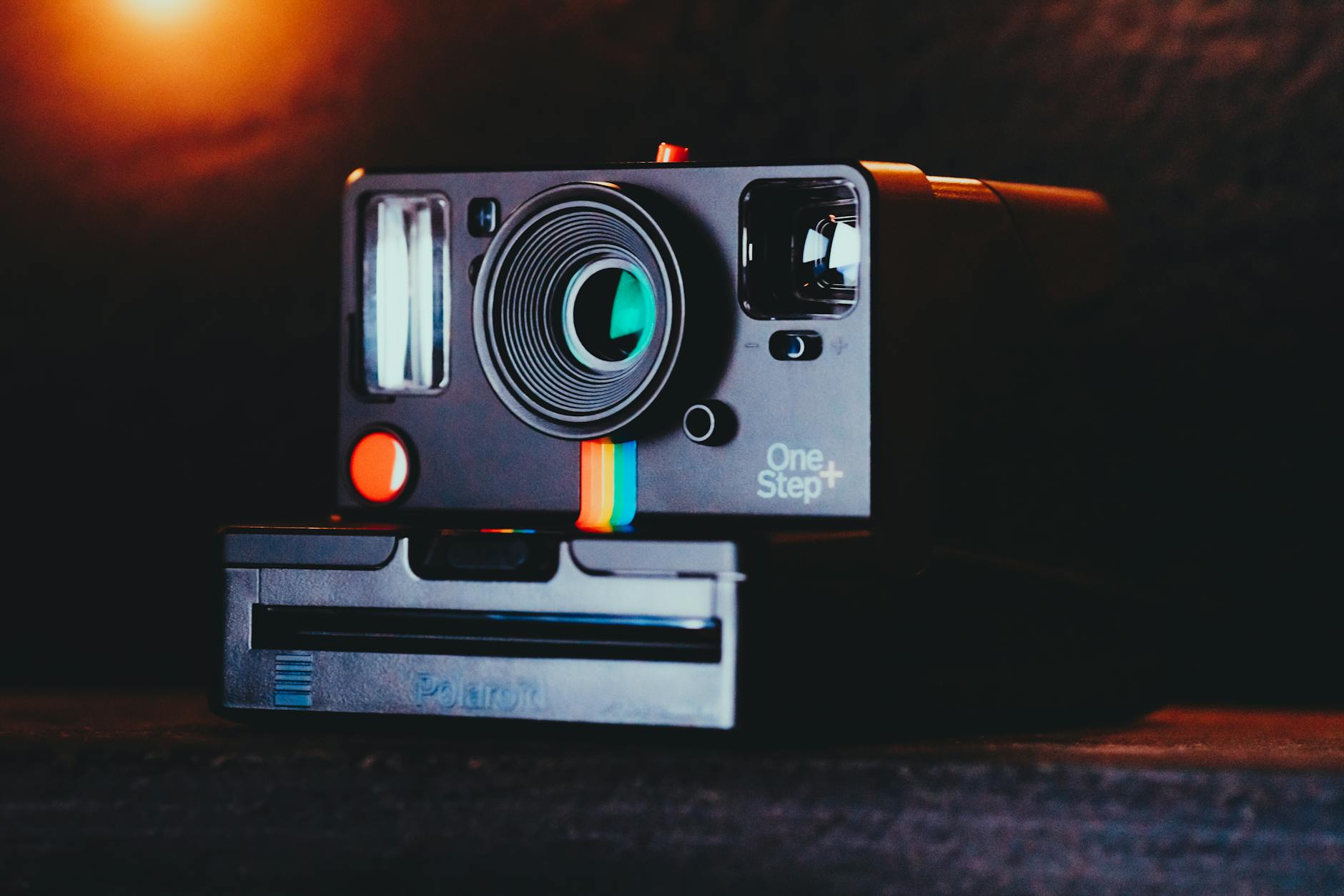 Close-up of a classic Polaroid One Step camera under warm light.