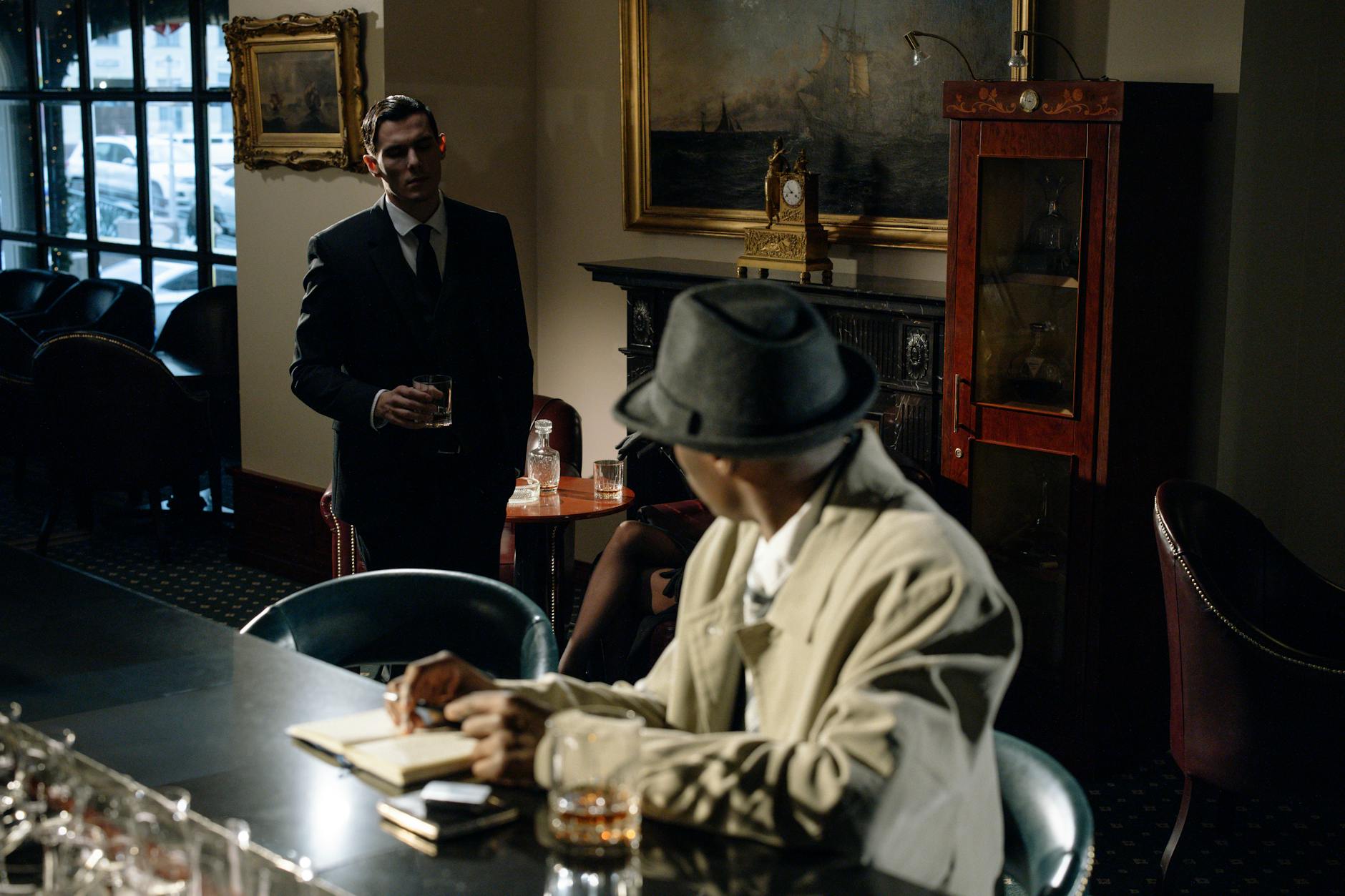 Mysterious noir-style scene with two men in a vintage bar, exuding a moody 20th-century ambiance.